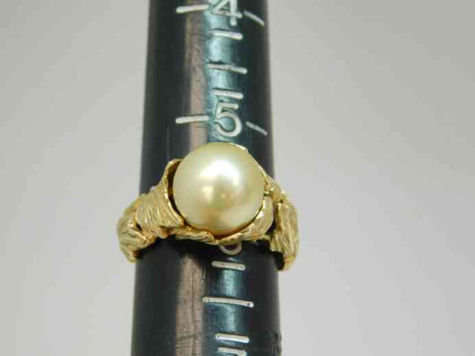 Antique solitaire pearl ring set into 14k gold sculpted leaves band