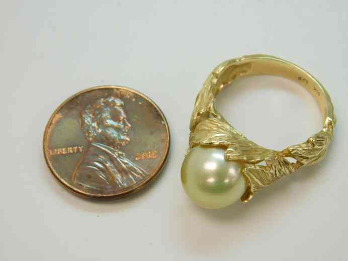 Antique solitaire pearl ring set into 14k gold sculpted leaves band