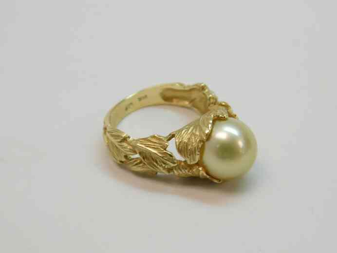 Antique solitaire pearl ring set into 14k gold sculpted leaves band